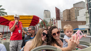 Tourists enjoying the red city sightseeing Hop-on Hop-off bus in New Orleans: Fun-filled moments of bus rides, selfies, and guided exploration.